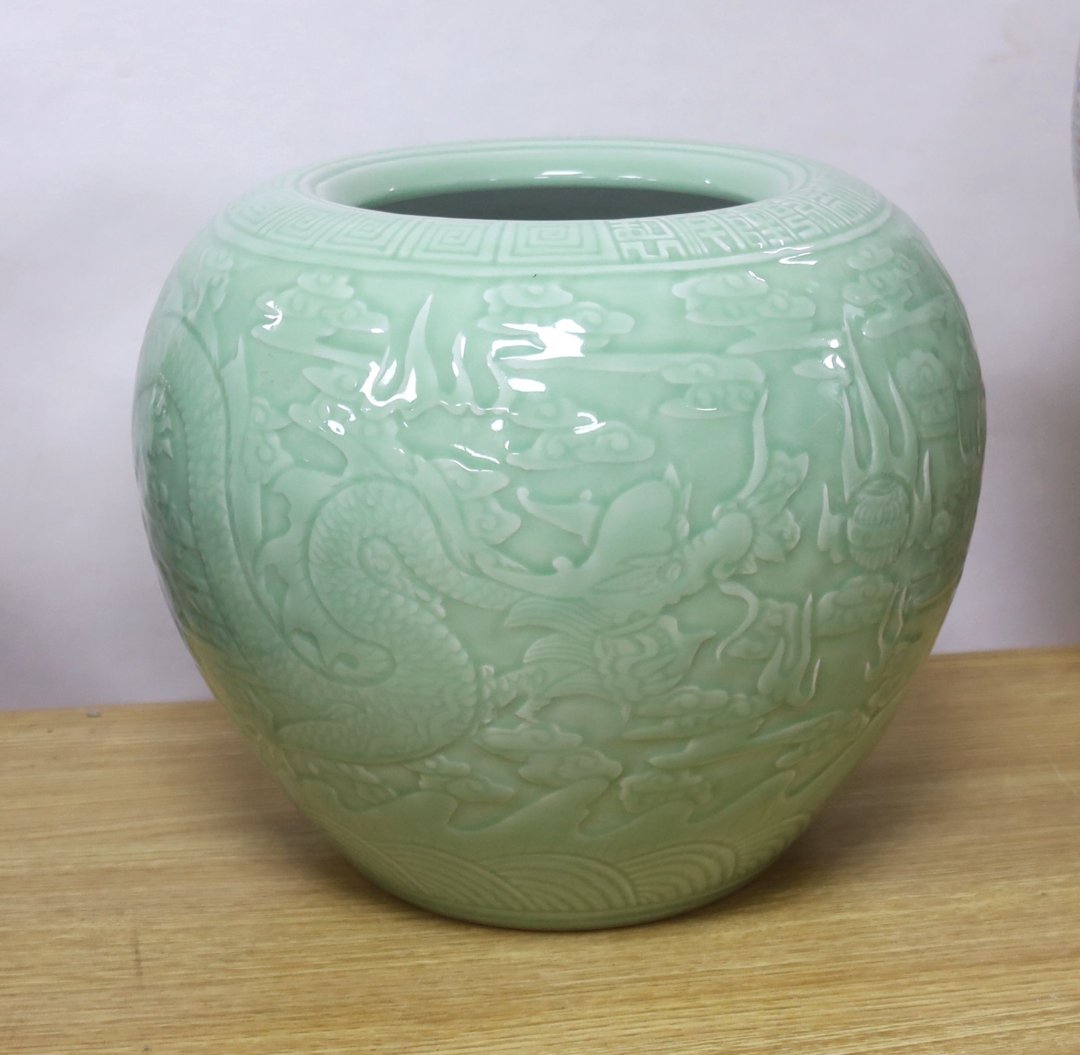 A large Chinese celadon glazed 'dragon' jardiniere or fish bowl 29cm